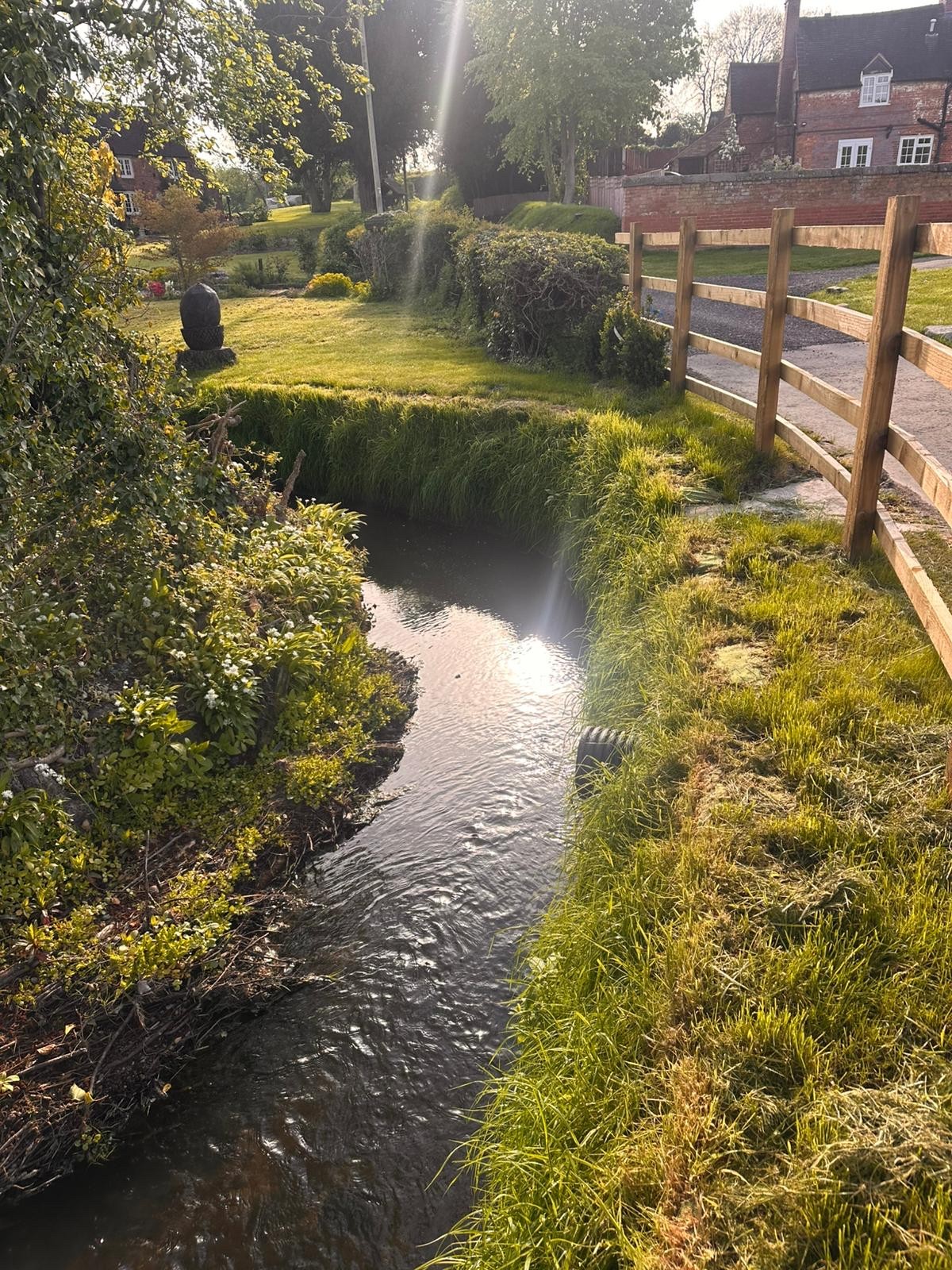 Channel next to road with low flow level